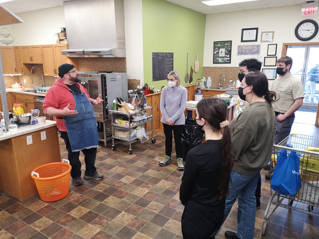 volunteers in learning kitchen with Chef Yves